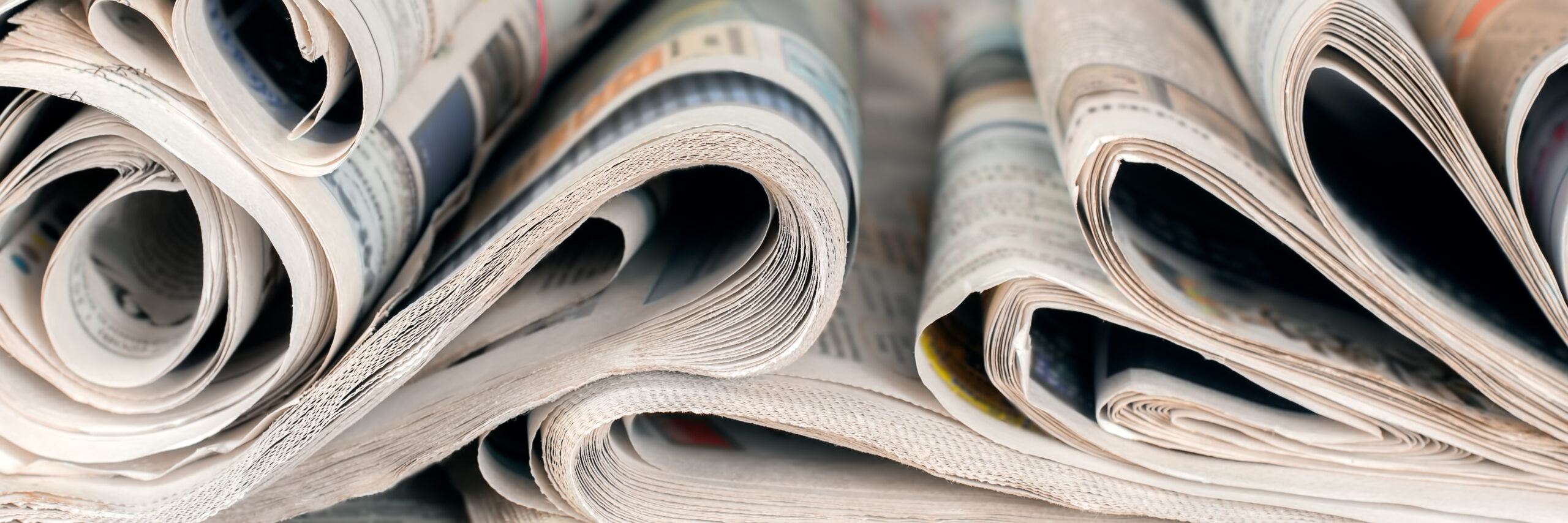 Newspapers, world news information concept, close-up, panoramic